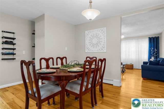 3079 Eldridge Ave, Palmer Twp, PA 18045 - dining space featuring light wood-style flooring, baseboards, and a baseboard radiator