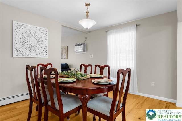 3079 Eldridge Ave, Palmer Twp, PA 18045 - dining space with wood finished floors, a wall mounted AC, and a baseboard radiator