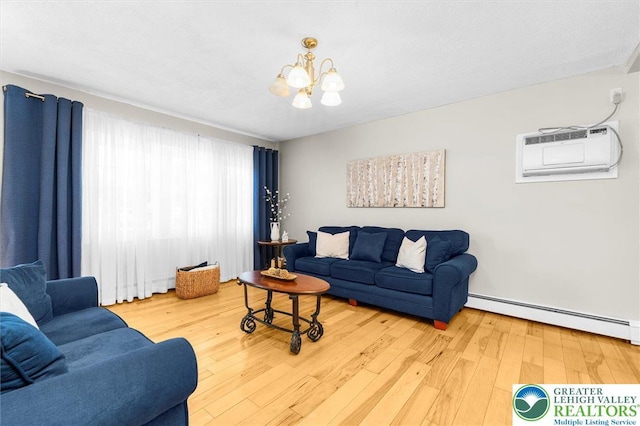 3079 Eldridge Ave, Palmer Twp, PA 18045 - living room with a baseboard heating unit, a wall mounted AC, a chandelier, and wood-type flooring