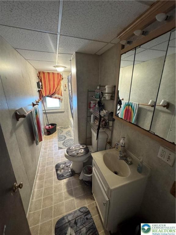 109 S Chestnut St, Summit Hill Borough, PA 18250 - bathroom featuring a paneled ceiling, vanity, a shower, toilet, and tile patterned flooring