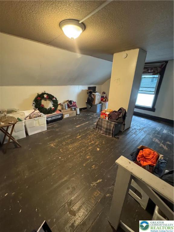 109 S Chestnut St, Summit Hill Borough, PA 18250 - bonus room with wood-type flooring, a textured ceiling, and lofted ceiling