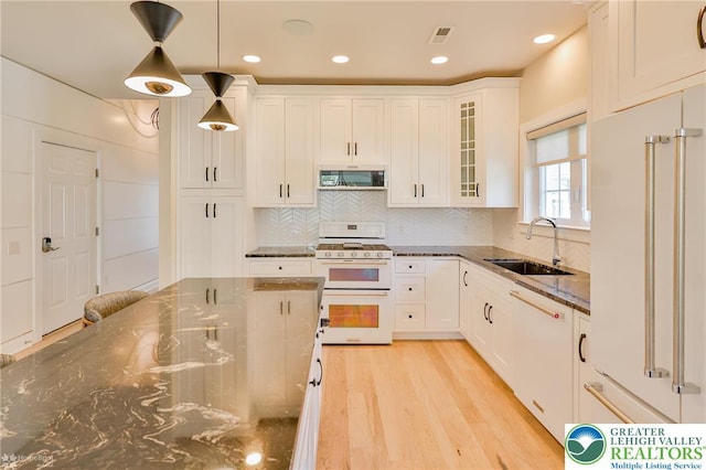 3896 Independence Dr, Easton, PA 18045 - kitchen featuring white appliances, a sink, dark stone counters, white cabinetry, and recessed lighting