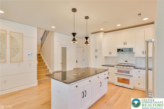 3896 Independence Dr, Easton, PA 18045 - kitchen with white appliances, white cabinets, light wood-style flooring, dark stone counters, and recessed lighting