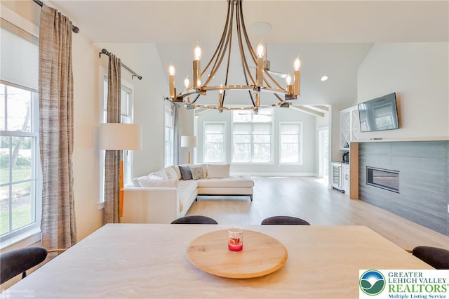 3896 Independence Dr, Easton, PA 18045 - dining area featuring a chandelier, a fireplace, plenty of natural light, and high vaulted ceiling