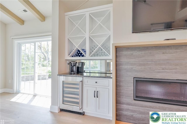 3896 Independence Dr, Easton, PA 18045 - indoor dry bar featuring beverage cooler, beamed ceiling, plenty of natural light, baseboards, and light wood-style flooring