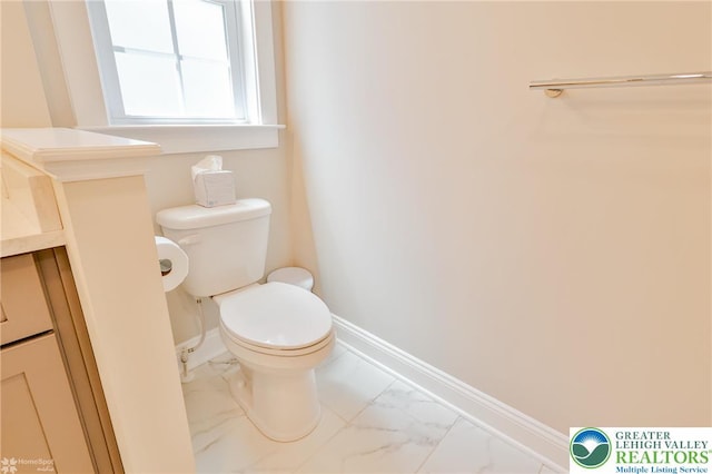 3896 Independence Dr, Easton, PA 18045 - half bath featuring marble look tiles, toilet, baseboards, and vanity