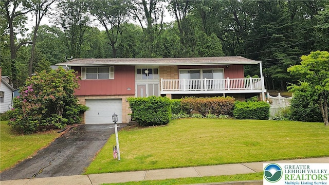 1426 Church St, Fountain Hill Boro, PA 18015 - split foyer home featuring an attached garage, asphalt driveway, brick siding, a front yard, and board and batten siding