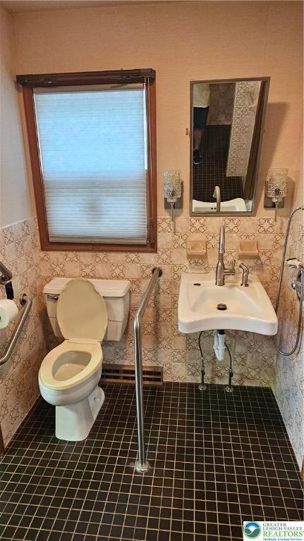 1426 Church St, Fountain Hill Boro, PA 18015 - bathroom with toilet, tile walls, tile patterned floors, a wainscoted wall, and a sink