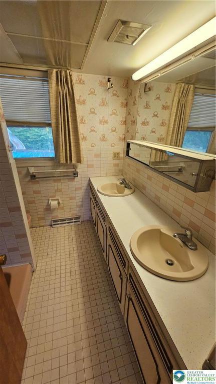 1426 Church St, Fountain Hill Boro, PA 18015 - bathroom with double vanity, wallpapered walls, tile walls, and tile patterned flooring