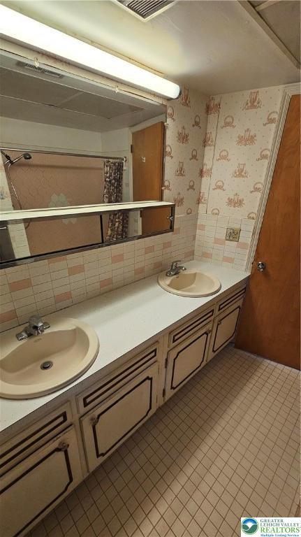 1426 Church St, Fountain Hill Boro, PA 18015 - bathroom featuring double vanity, wallpapered walls, and tile patterned floors
