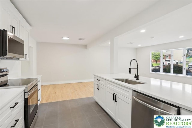 624 E 8th St, Northampton Borough, PA 18067 - kitchen with appliances with stainless steel finishes, a sink, light countertops, white cabinetry, and recessed lighting