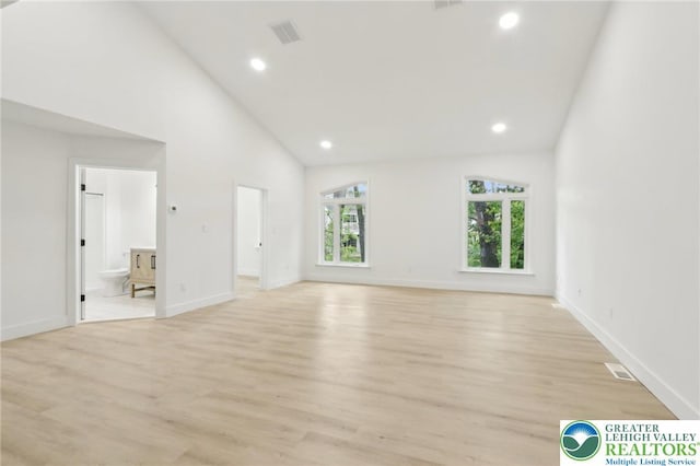 624 E 8th St, Northampton Borough, PA 18067 - unfurnished living room with light wood-style flooring, recessed lighting, high vaulted ceiling, and baseboards