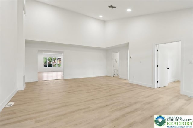 624 E 8th St, Northampton Borough, PA 18067 - empty room featuring a high ceiling, light wood-style floors, baseboards, and recessed lighting