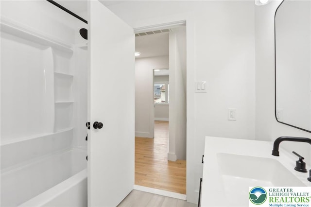 624 E 8th St, Northampton Borough, PA 18067 - bathroom featuring wood finished floors, baseboards, shower / washtub combination, and vanity