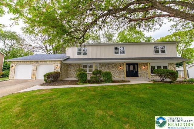 1360 Cherry Ave, Hanover Twp, PA 18017 - traditional-style house with stone siding, concrete driveway, a front lawn, and an attached garage