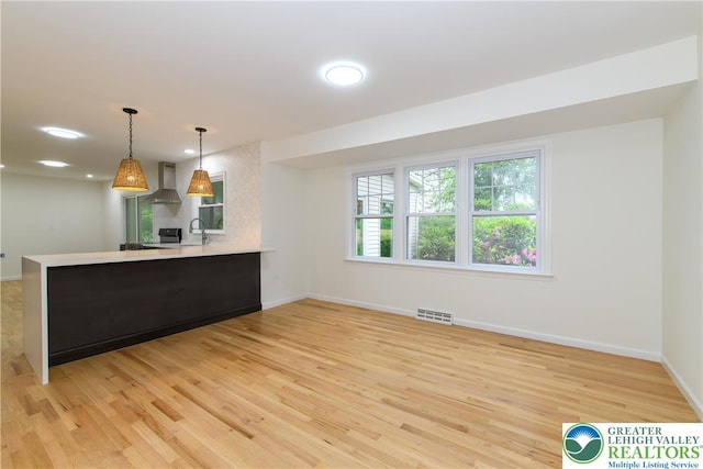 1360 Cherry Ave, Hanover Twp, PA 18017 - kitchen with wall chimney exhaust hood, light wood-style flooring, a peninsula, baseboards, and recessed lighting