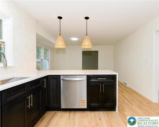 1360 Cherry Ave, Hanover Twp, PA 18017 - kitchen with dishwasher, a sink, light wood-style floors, a peninsula, and light countertops