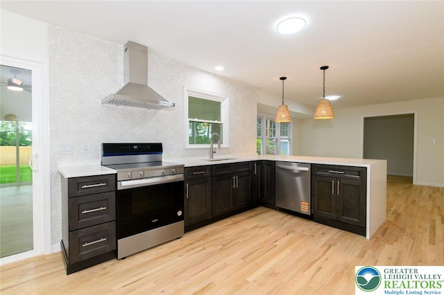 1360 Cherry Ave, Hanover Twp, PA 18017 - kitchen with stainless steel appliances, wall chimney exhaust hood, a sink, light wood-style floors, and a peninsula