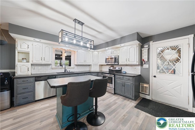 2617 5th St, Bethlehem City, PA 18020 - kitchen featuring appliances with stainless steel finishes, dark countertops, white cabinets, gray cabinets, and a sink
