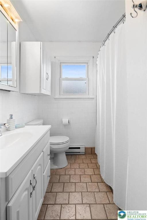 956 E Linden St, Allentown City, PA 18109 - bathroom featuring baseboard heating, vanity, tile walls, toilet, and brick patterned floors