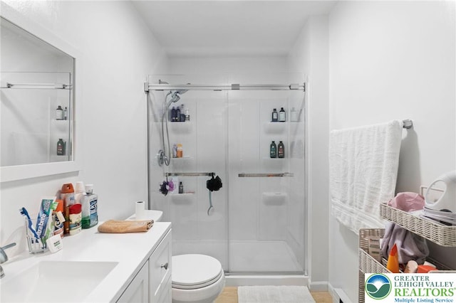 956 E Linden St, Allentown City, PA 18109 - bathroom with a stall shower, toilet, vanity, and wood finished floors