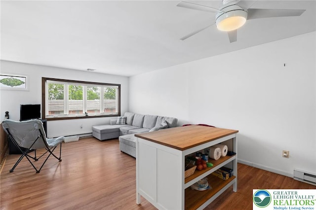 956 E Linden St, Allentown City, PA 18109 - living area with light wood finished floors, a baseboard heating unit, and ceiling fan