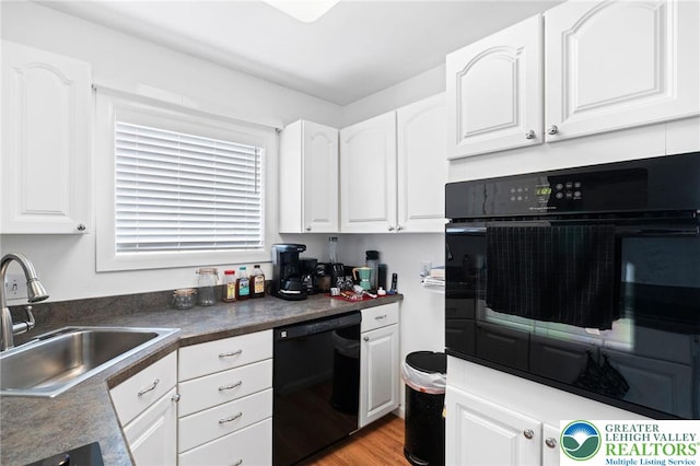 956 E Linden St, Allentown City, PA 18109 - kitchen featuring black appliances, a sink, white cabinetry, light wood finished floors, and dark countertops