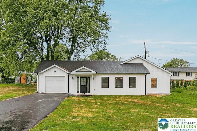 1647 4th St, Bethlehem Twp, PA 18020 - view of front facade with a garage, asphalt driveway, and a front yard