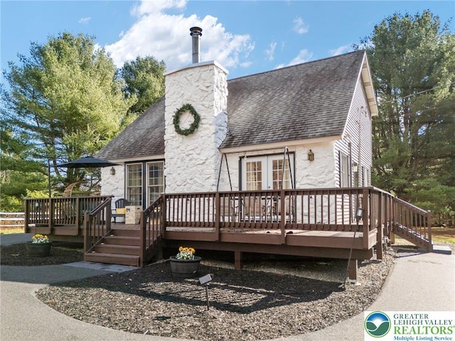 64 Autumn Ln, Penn Forest Twp, PA 18229 - view of front of house featuring roof with shingles, french doors, a deck, a chimney, and stone siding