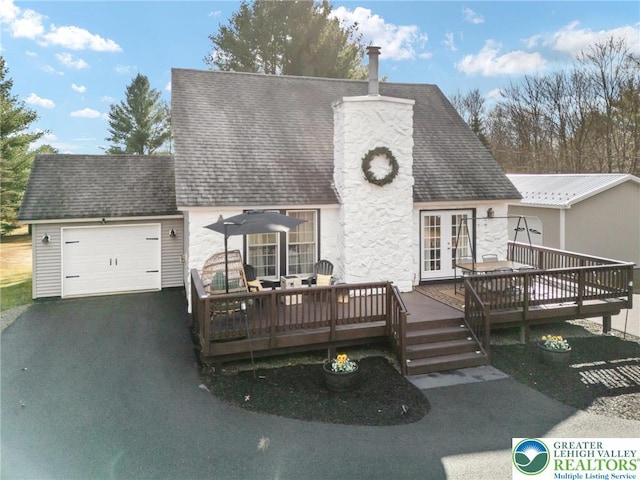 64 Autumn Ln, Penn Forest Twp, PA 18229 - back of property featuring french doors, asphalt driveway, a wooden deck, and a garage