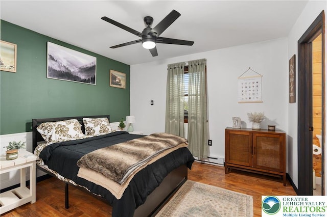 64 Autumn Ln, Penn Forest Twp, PA 18229 - bedroom with wood finished floors, a ceiling fan, and a baseboard heating unit