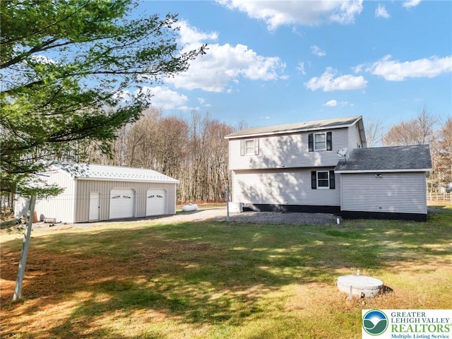 64 Autumn Ln, Penn Forest Twp, PA 18229 - back of house featuring a garage, an outbuilding, and a yard
