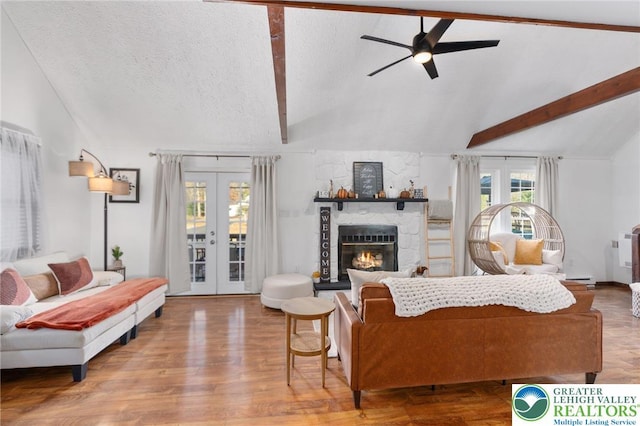 64 Autumn Ln, Penn Forest Twp, PA 18229 - living room featuring french doors, a ceiling fan, a stone fireplace, wood finished floors, and a textured ceiling