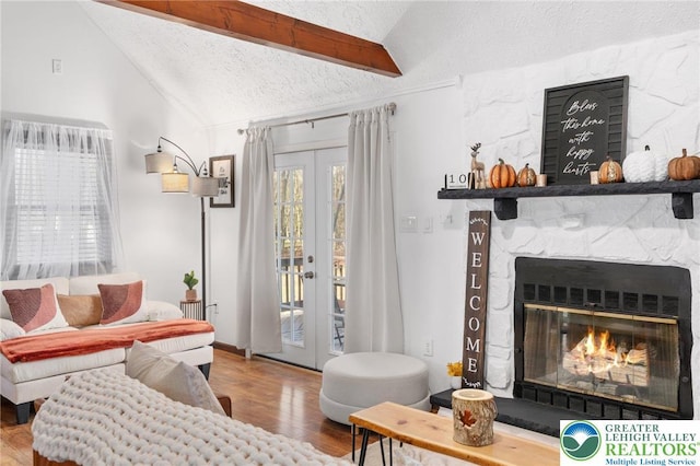 64 Autumn Ln, Penn Forest Twp, PA 18229 - living area featuring a textured ceiling, wood finished floors, french doors, and a stone fireplace