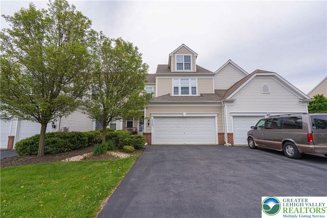 8592 Cascade Rd, Upper Macungie Twp, PA 18031 - view of property with driveway, brick siding, an attached garage, and a shingled roof