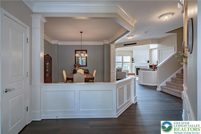 8592 Cascade Rd, Upper Macungie Twp, PA 18031 - hallway featuring decorative columns, ornamental molding, a chandelier, dark wood finished floors, and stairs