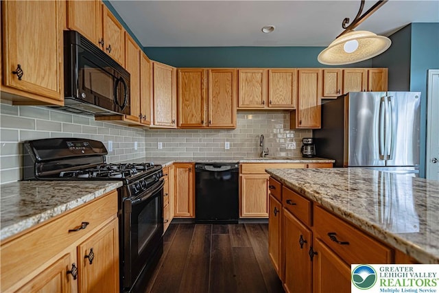 8592 Cascade Rd, Upper Macungie Twp, PA 18031 - kitchen featuring black appliances, a sink, dark wood-style flooring, and light stone counters
