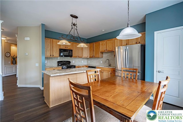 8592 Cascade Rd, Upper Macungie Twp, PA 18031 - kitchen with black microwave, freestanding refrigerator, range, a kitchen island, and dark wood-style floors
