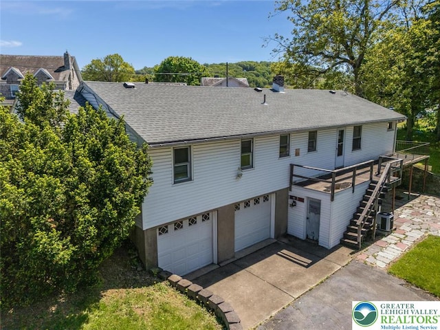 825 Old Philadelphia Rd, Easton, PA 18042 - back of house with an attached garage, central AC unit, stairway, roof with shingles, and driveway