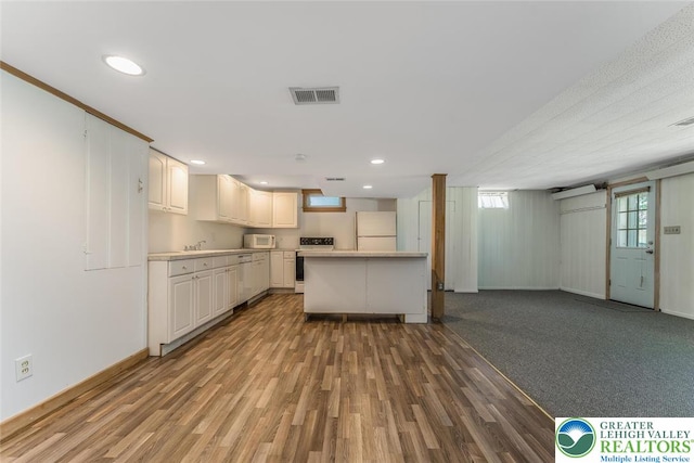 825 Old Philadelphia Rd, Easton, PA 18042 - kitchen featuring white appliances, light countertops, open floor plan, wood finished floors, and baseboards