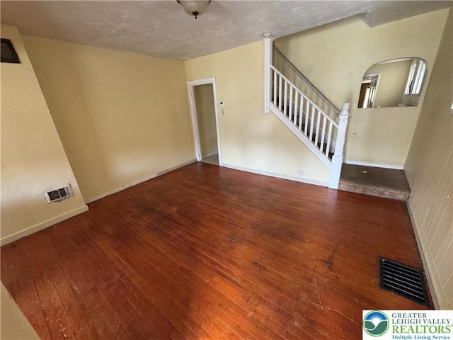 226 Adrain St, Emmaus Boro, PA 18049 - empty room featuring hardwood / wood-style flooring, arched walkways, stairway, baseboards, and a textured ceiling