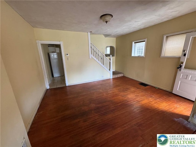226 Adrain St, Emmaus Boro, PA 18049 - unfurnished living room featuring stairway, hardwood / wood-style flooring, baseboards, and arched walkways
