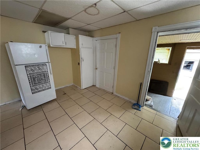 226 Adrain St, Emmaus Boro, PA 18049 - kitchen featuring freestanding refrigerator, white cabinets, a drop ceiling, light tile patterned floors, and baseboards