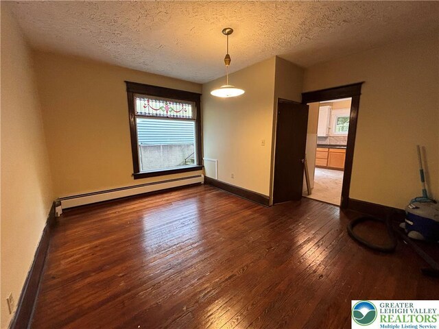 613 S Main St, Bangor Borough, PA 18013 - spare room featuring a baseboard heating unit, hardwood / wood-style floors, a textured ceiling, and baseboards