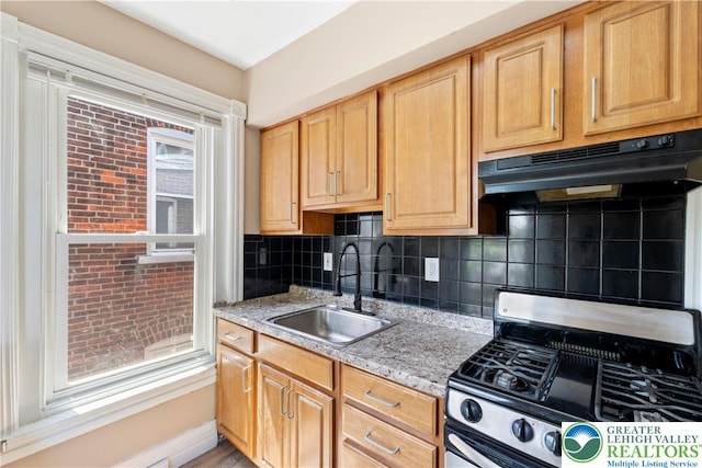 343 N 16th St, Allentown City, PA 18102 - kitchen with stainless steel range with gas cooktop, under cabinet range hood, a sink, decorative backsplash, and light stone counters