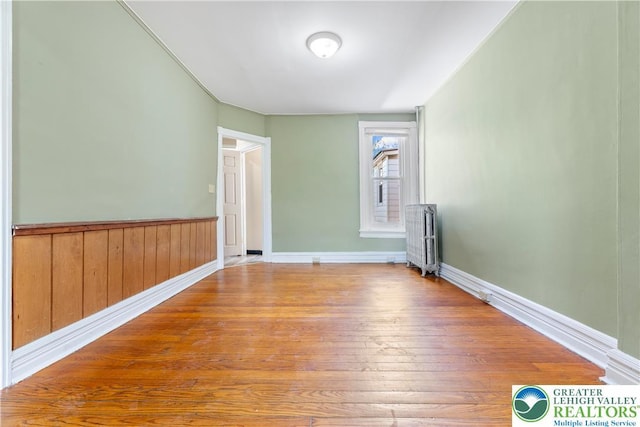 343 N 16th St, Allentown City, PA 18102 - spare room with radiator, wood finished floors, and wainscoting