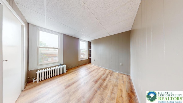 853 N Jordan St, Allentown City, PA 18102 - empty room featuring radiator heating unit, wood finished floors, and a drop ceiling