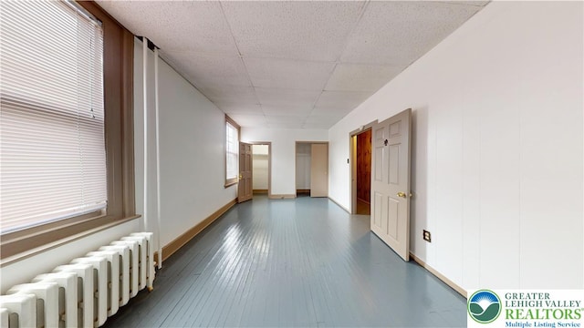 853 N Jordan St, Allentown City, PA 18102 - corridor featuring radiator heating unit, baseboards, a paneled ceiling, and wood finished floors