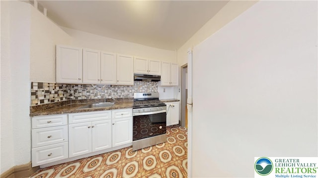 853 N Jordan St, Allentown City, PA 18102 - kitchen featuring gas range, under cabinet range hood, white cabinetry, dark countertops, and backsplash