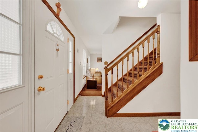 146 Bernadette Dr, Pike, PA 18328 - entryway featuring stairway, light tile patterned flooring, and baseboards